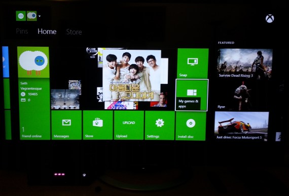 An off-TV shot of the Xbox One UI. The picture in the middle comes from my Apple TV.